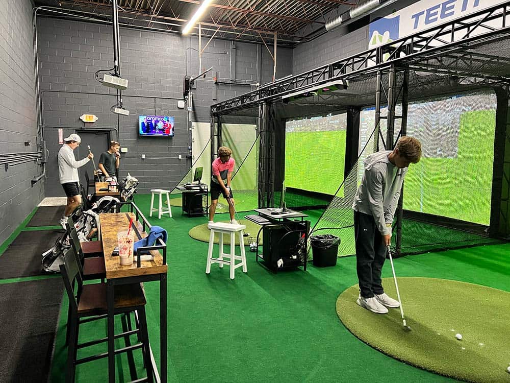 high school golfers practice at tee it up canton
